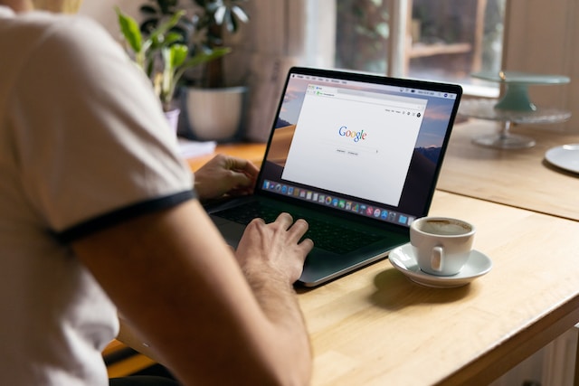 A person using a laptop for Google search