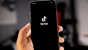 user holding smartphone with TikTok app